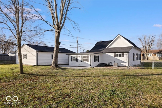 rear view of house with a yard, central AC, and a patio area