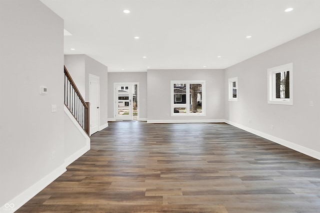 unfurnished living room with dark hardwood / wood-style flooring