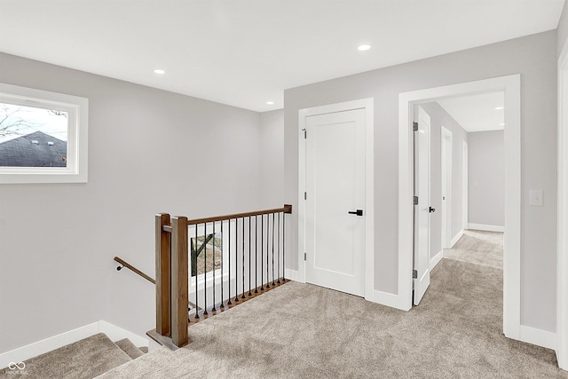 hallway featuring light carpet