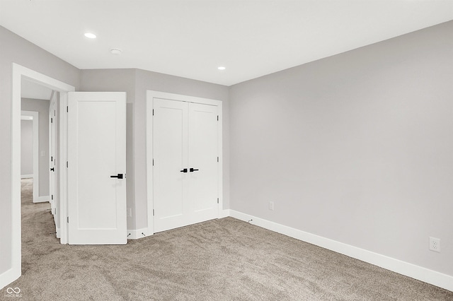 unfurnished bedroom with carpet and a closet