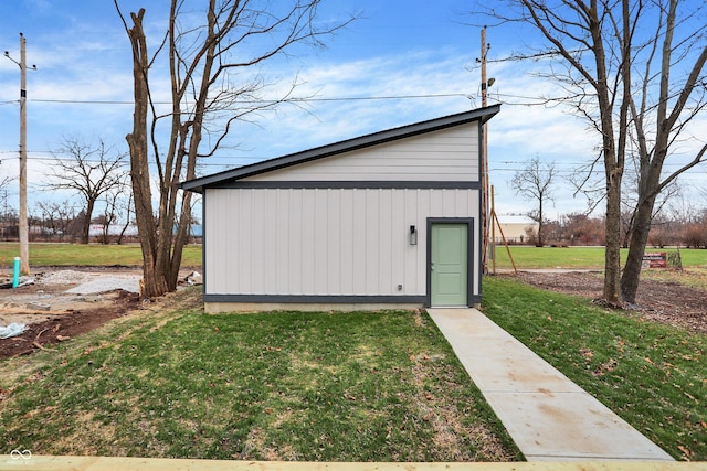 view of outbuilding featuring a lawn