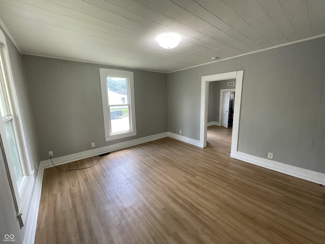 spare room featuring wood ceiling, crown molding, and wood-type flooring