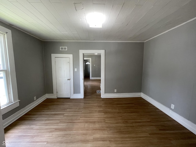 unfurnished room featuring light hardwood / wood-style floors, crown molding, and wood ceiling