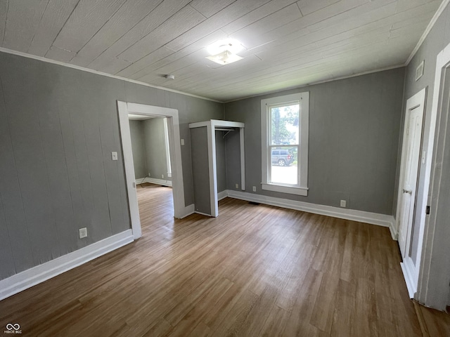 unfurnished bedroom featuring wood-type flooring, crown molding, and wood ceiling