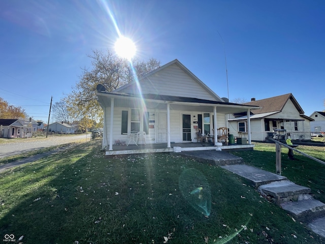 bungalow-style home featuring a porch and a front lawn