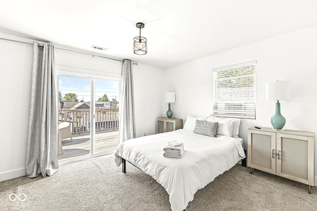 carpeted bedroom with access to outside and multiple windows