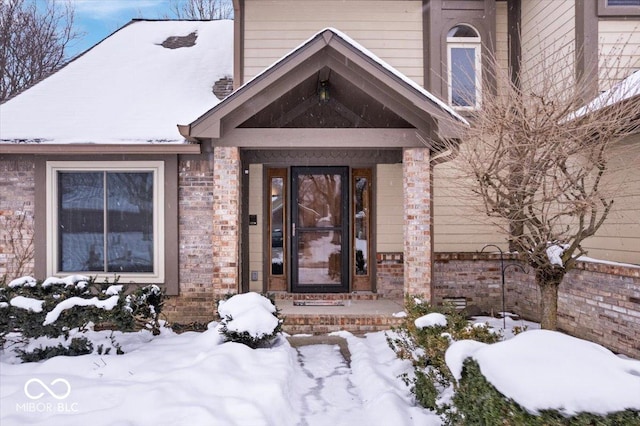 view of snow covered property entrance