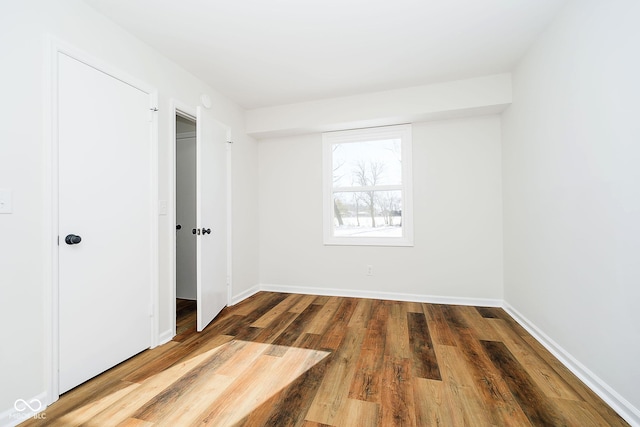 unfurnished bedroom featuring hardwood / wood-style flooring