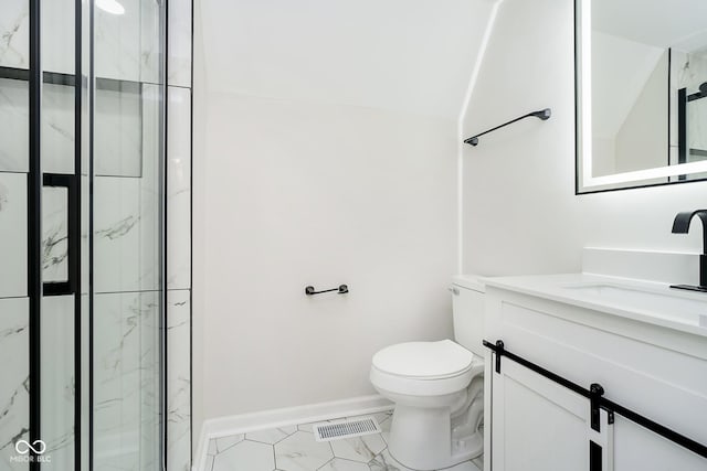 bathroom with vanity, a shower with door, and toilet