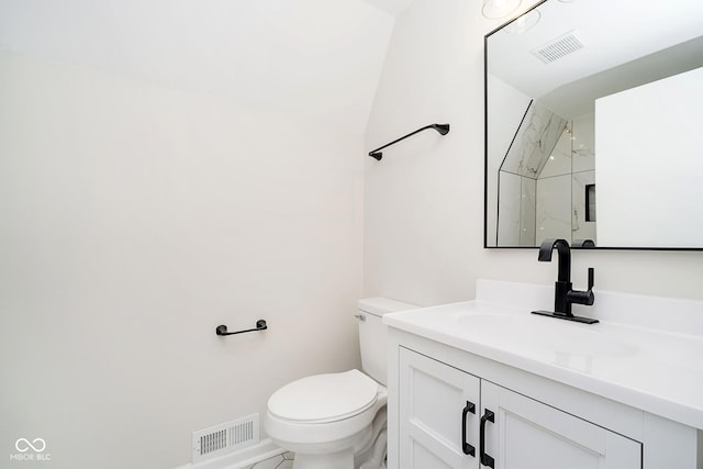 bathroom with vanity, a shower, and toilet