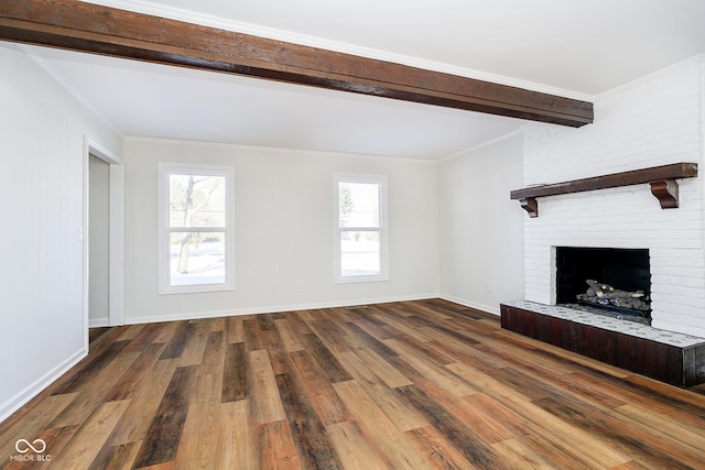 unfurnished living room featuring crown molding, a fireplace, dark hardwood / wood-style floors, and plenty of natural light