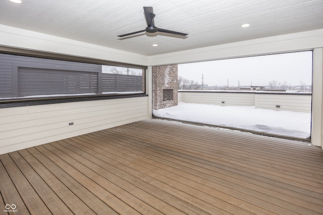 wooden deck featuring a fireplace and ceiling fan