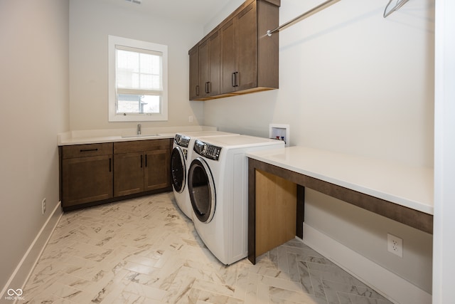 laundry room with sink, cabinets, and independent washer and dryer