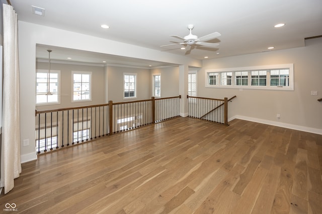 spare room featuring wood-type flooring and ceiling fan