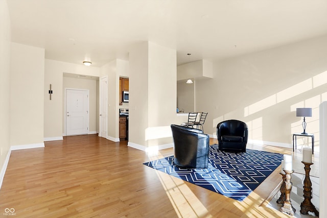 sitting room with hardwood / wood-style flooring