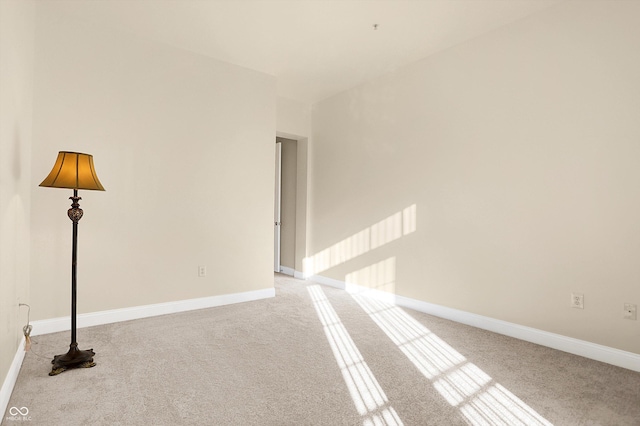 spare room featuring light colored carpet