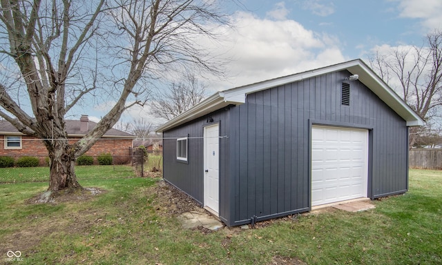 view of outbuilding with a yard and a garage