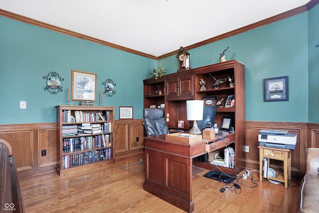 office with light hardwood / wood-style flooring and ornamental molding