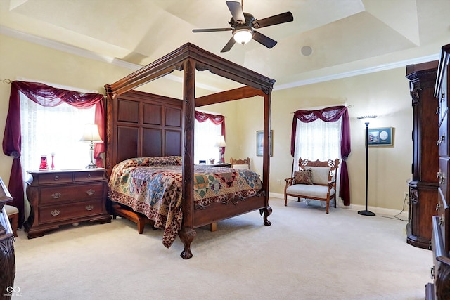 bedroom with light carpet, a raised ceiling, ceiling fan, and crown molding