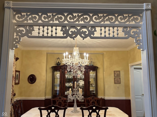 dining space with crown molding and a notable chandelier