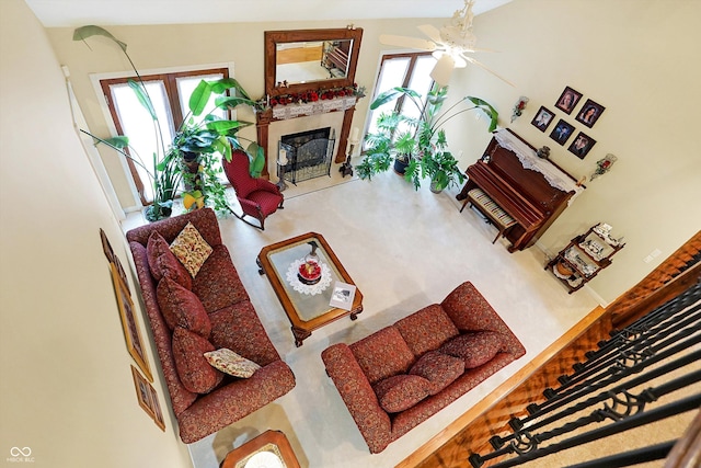 living room featuring ceiling fan and a healthy amount of sunlight