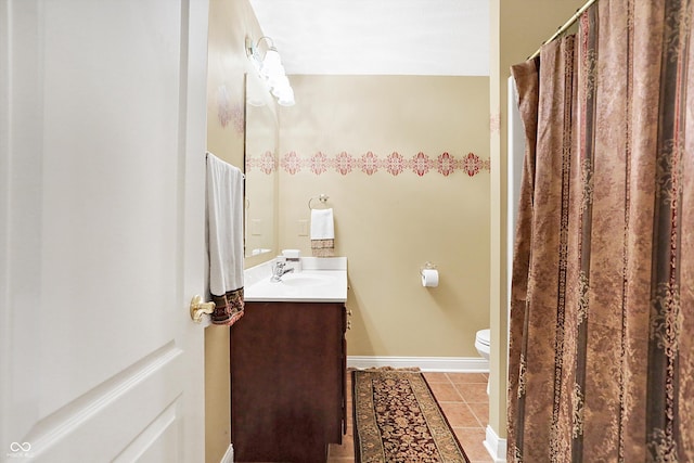 bathroom with tile patterned floors, vanity, and toilet