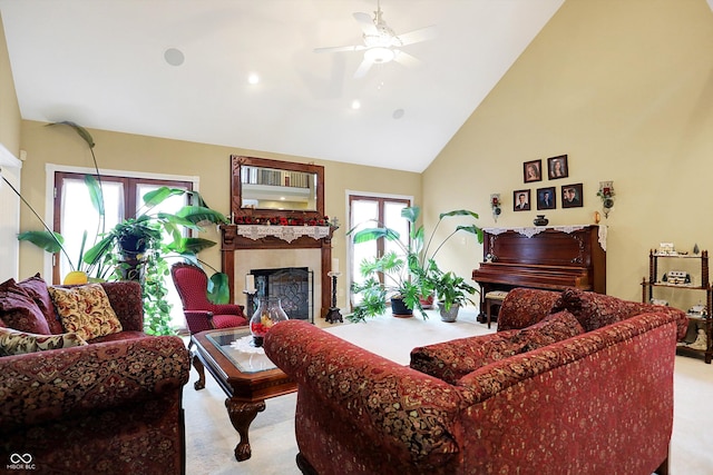 carpeted living room with high vaulted ceiling, a wealth of natural light, and ceiling fan