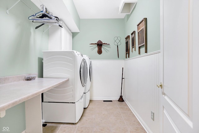 1398 Penny Ln, Greenfield, IN 46140 - laundry room with washer and clothes dryer, light tile patterned flooring, and wainscoting