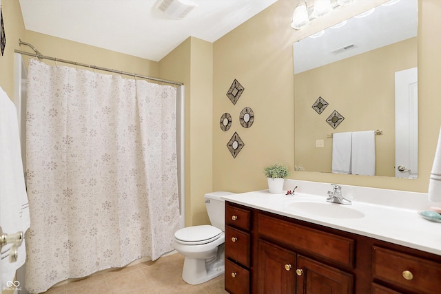 bathroom with tile patterned flooring, vanity, and toilet