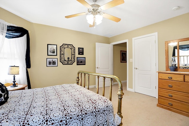 bedroom featuring ceiling fan and light carpet