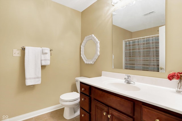 bathroom with tile patterned floors, vanity, toilet, and curtained shower