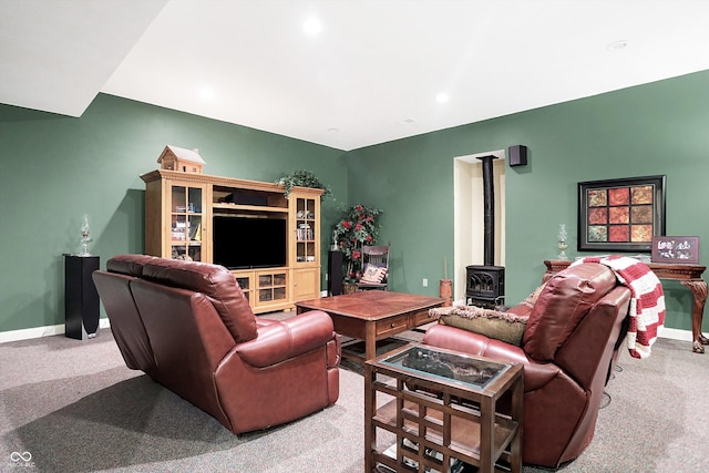 living room with light colored carpet and a wood stove