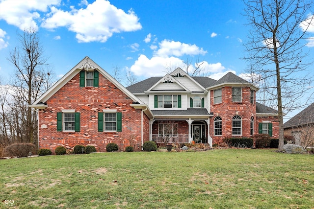 view of front facade with a front lawn and covered porch