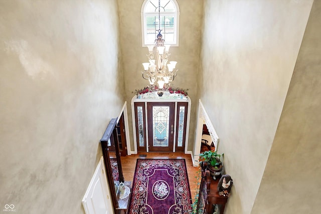 entryway with a high ceiling and an inviting chandelier