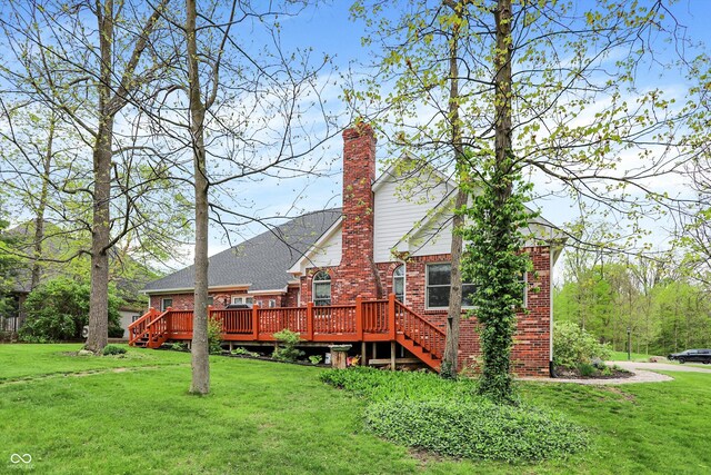 back of house featuring a wooden deck, a yard, stairway, and brick siding
