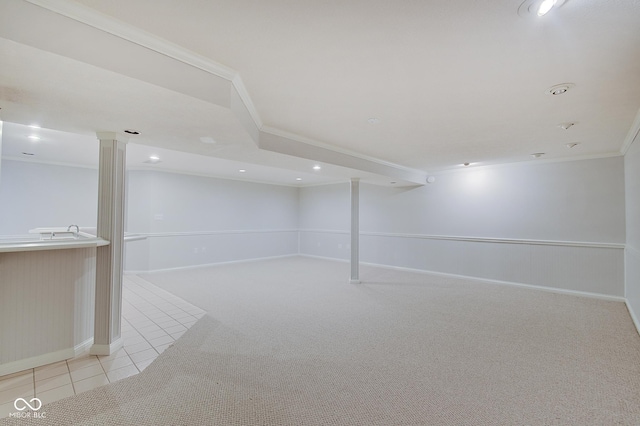 basement featuring ornamental molding and light carpet