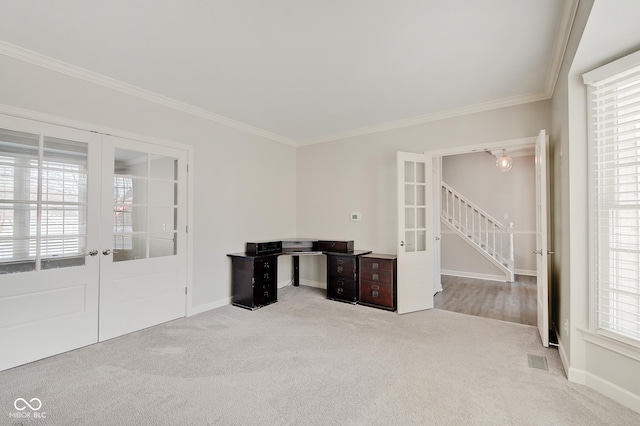 interior space with a wealth of natural light, french doors, light colored carpet, and ornamental molding