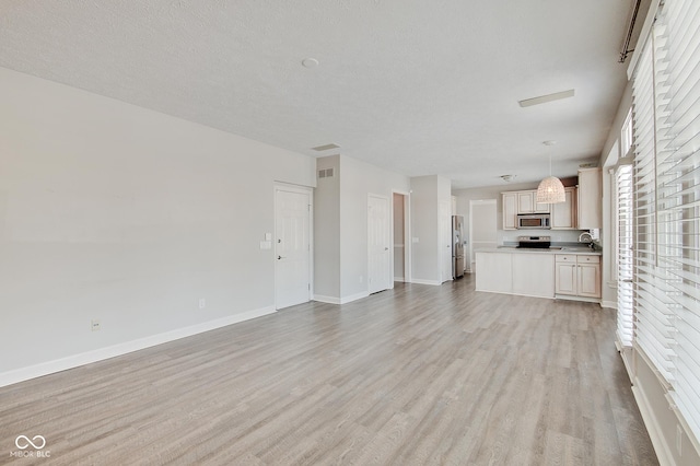 unfurnished living room featuring sink and light wood-type flooring