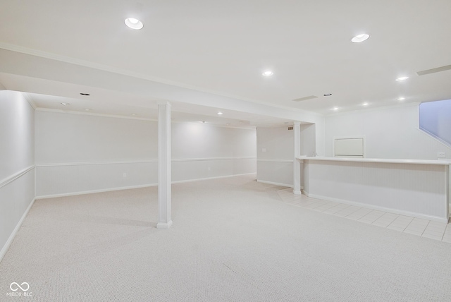 basement with ornamental molding and light carpet