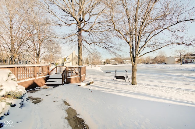 snowy yard with a wooden deck