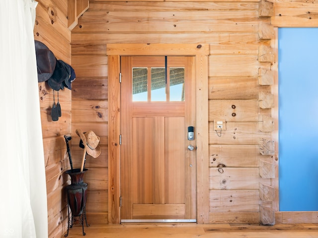 entryway featuring wood walls