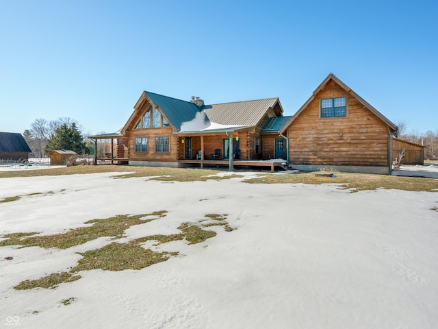 log cabin featuring covered porch