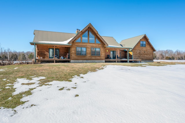 log-style house featuring covered porch