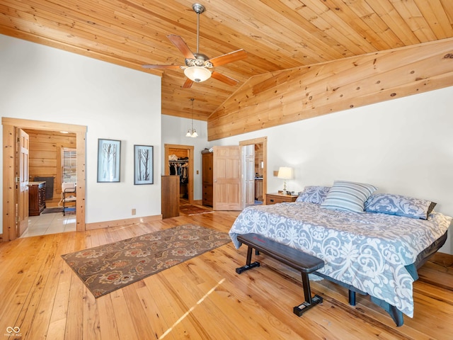 bedroom featuring high vaulted ceiling, a spacious closet, ceiling fan, wood ceiling, and light wood-type flooring