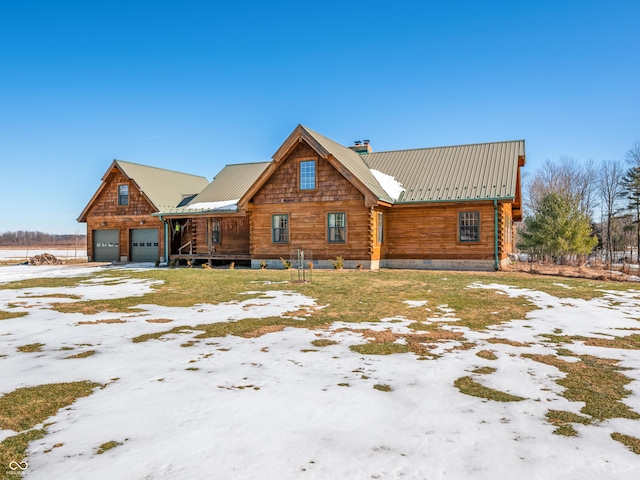 log-style house with a garage