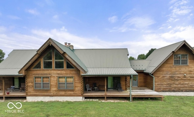 4210 S County Road 400 E, North Vernon, IN 47265 - back of property featuring a chimney, a lawn, a wooden deck, and a metal roof