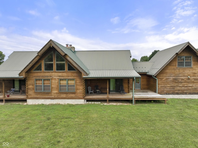 4210 S County Road 400 E, North Vernon, IN 47265 - rear view of house featuring a chimney, a lawn, a wooden deck, and a metal roof