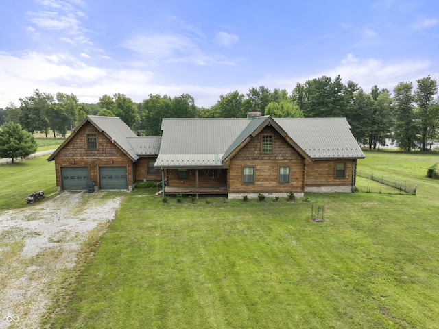 4210 S County Road 400 E, North Vernon, IN 47265 - log cabin with a garage, driveway, a chimney, a metal roof, and view of wooded area