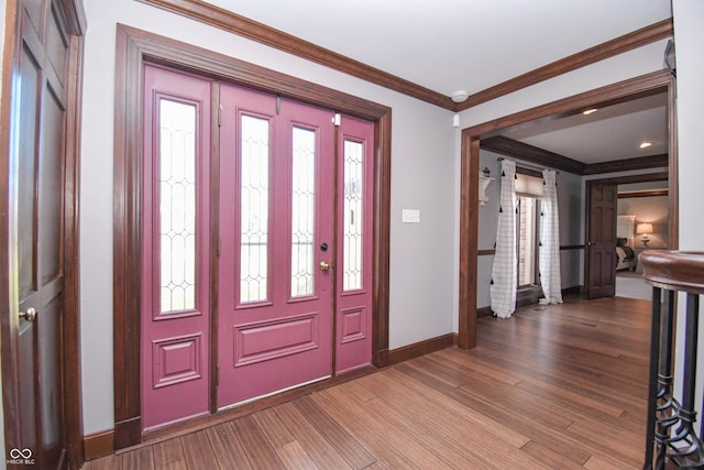 foyer entrance with wood-type flooring and ornamental molding