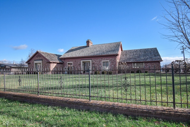 rear view of house with a lawn